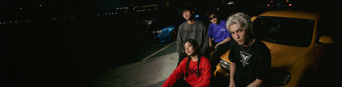 VAGRANT IV crew wearing graphic streetwear at night